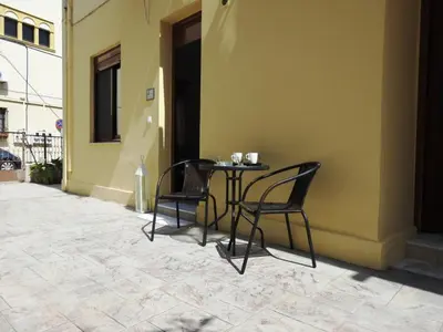 two chairs and a table on the side of a building at Kathopouli Apartment in Rhodes Town