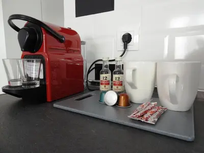 a red toaster and two bottles of alcohol on a counter at Kathopouli Apartment in Rhodes Town