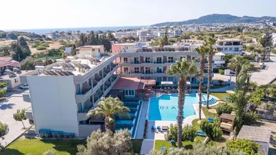 an aerial view of a hotel with a pool and palm trees at Dias Studios & Suites in Faliraki