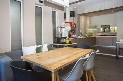 a dining room with a wooden table and chairs at Dias Studios & Suites in Faliraki