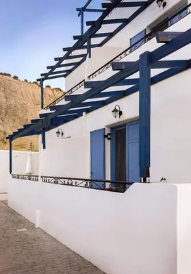 a white building with blue beams on it at Pontoria Stegna Studios in Archangelos
