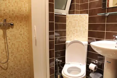 a bathroom with a toilet and a sink at Philoxenia Hotel & Studios in Rhodes Town