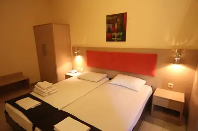 a hotel room with two beds with towels on them at Philoxenia Hotel & Studios in Rhodes Town