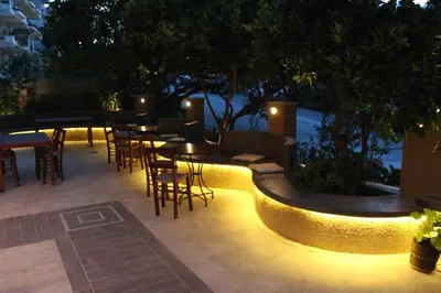 a patio with tables and chairs at night at Philoxenia Hotel & Studios in Rhodes Town