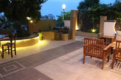 a patio with chairs and a table with lights at Philoxenia Hotel & Studios in Rhodes Town