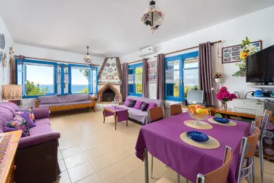 a living room with a purple table and chairs at Villa Lia Panorama in Pefki Rhodes