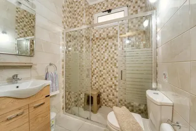 a bathroom with a shower and a toilet and a sink at Villa Lia Panorama in Pefki Rhodes