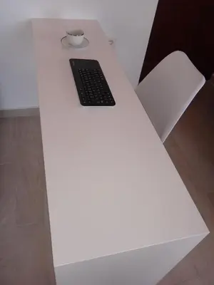 a white table with a keyboard and a cup on it at Aegean View Villas in Halki