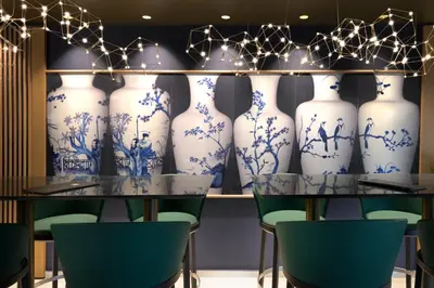 a room with blue and white vases on display at Olympic Palace Hotel in Ixia