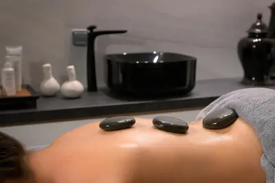 a person laying in a bath tub with a spavisorvisor at Olympic Palace Hotel in Ixia