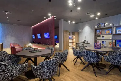 a restaurant with tables and chairs in a room at Olympic Palace Hotel in Ixia