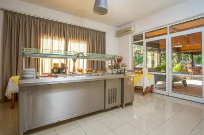 a kitchen with a counter with dishes on it at Mon Repos Hotel in Faliraki