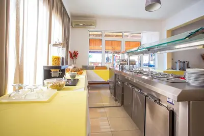 a kitchen with a long counter in a kitchen at Mon Repos Hotel in Faliraki