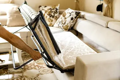 a person is holding a bed in a living room at Lindos Luxury Retro Villas in Líndos