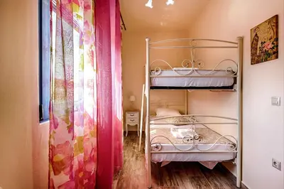 a bedroom with two bunk beds and a window at Lindos Luxury Retro Villas in Líndos