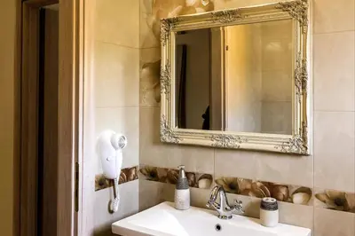 a bathroom with a sink and a mirror at Lindos Luxury Retro Villas in Líndos