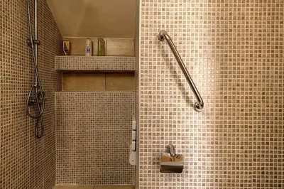 a bathroom with a shower with a sink at Lindos Luxury Retro Villas in Líndos