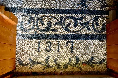 a mosaic wall with the words welcome to iraq at Lindos Esel Suites in Líndos