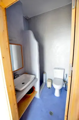 a small bathroom with a toilet and a sink at Lindos Esel Suites in Líndos