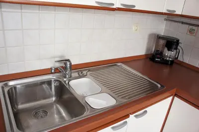 a kitchen sink with a strainer next to it at Rodos Beach in Archangelos