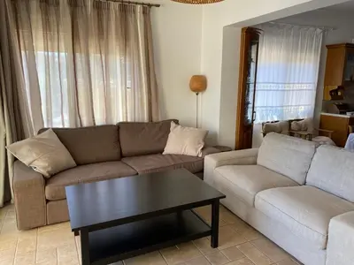 a living room with two couches and a coffee table at Kaya Sea Studios - Stegna Beach in Archangelos