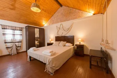 a bedroom with a bed and a wooden ceiling at The old town Neighbourhood in Rhodes Town