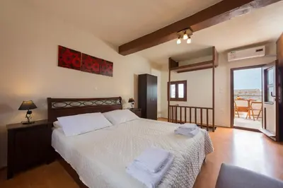 a bedroom with a bed with two towels on it at The old town Neighbourhood in Rhodes Town