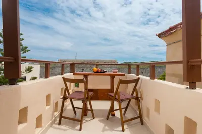 a balcony with a table and two chairs at The old town Neighbourhood in Rhodes Town
