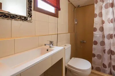 a bathroom with a toilet and a sink and a mirror at The old town Neighbourhood in Rhodes Town