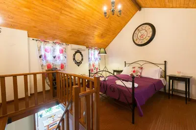 a bedroom with a bed and a clock on the wall at The old town Neighbourhood in Rhodes Town