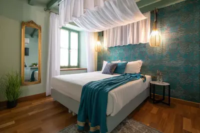 a bedroom with a bed with a blue wall at Sperveri Boutique Hotel in Rhodes Town