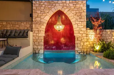 a swimming pool with a fountain in the middle of a building at Sperveri Boutique Hotel in Rhodes Town