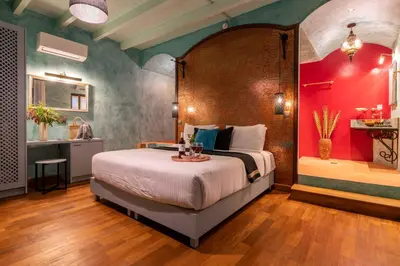 a bedroom with a large bed and a bathroom at Sperveri Boutique Hotel in Rhodes Town
