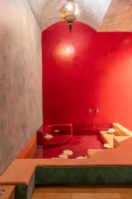 a red bathroom with a tub with a red wall at Sperveri Boutique Hotel in Rhodes Town
