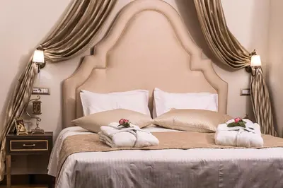 a bedroom with a large white bed with towels on it at Sperveri Boutique Hotel in Rhodes Town