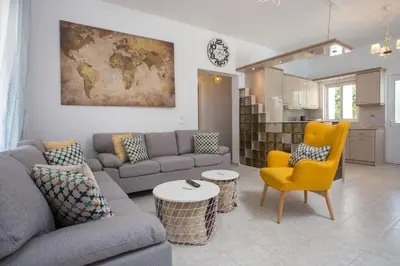 a living room with a couch and a table at Mythos Luxury Villa in Faliraki