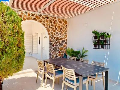 a dining room with a black table and chairs at Mythos Luxury Villa in Faliraki
