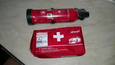 a red bottle of water next to a first aid kit at Amazing apartment 300 meters from the Old Town in Rhodes Town