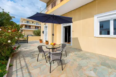 a table with chairs and an umbrella on a patio at Amazing apartment 300 meters from the Old Town in Rhodes Town
