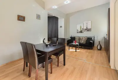 a living room with a table and chairs and a couch at Amazing apartment 300 meters from the Old Town in Rhodes Town