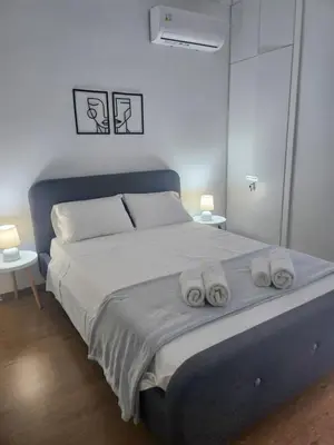 a bedroom with a large bed with towels on it at Harmony Elegant Central Apartment in Rhodes Town