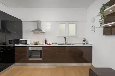 a kitchen with a sink and a stove top oven at Harmony Elegant Central Apartment in Rhodes Town