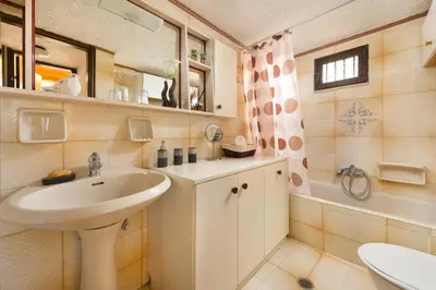 a bathroom with a sink and a mirror at Villa Agia Paraskevi in Ialyssos