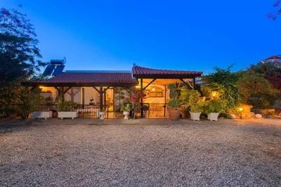 a house with a gate and potted plants in front of it at Villa Agia Paraskevi in Ialyssos