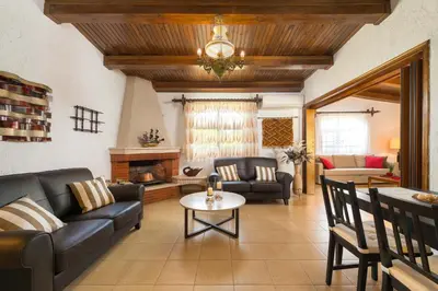 a living room with a couch and a table at Villa Agia Paraskevi in Ialyssos