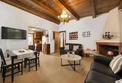 a living room with a couch and a table at Villa Agia Paraskevi in Ialyssos