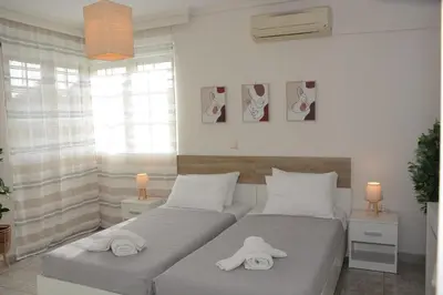 a bedroom with two beds with towels on them at Athina's Villa with heated pool in Koskinou