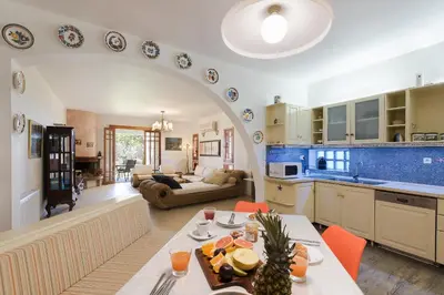 a kitchen and living room with an archway in a room at Villa Sole Mare in Pefki Rhodes