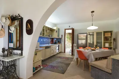 a kitchen with an archway and a table in a room at Villa Sole Mare in Pefki Rhodes