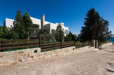 a house with a fence in front of it at Villa Sole Mare in Pefki Rhodes